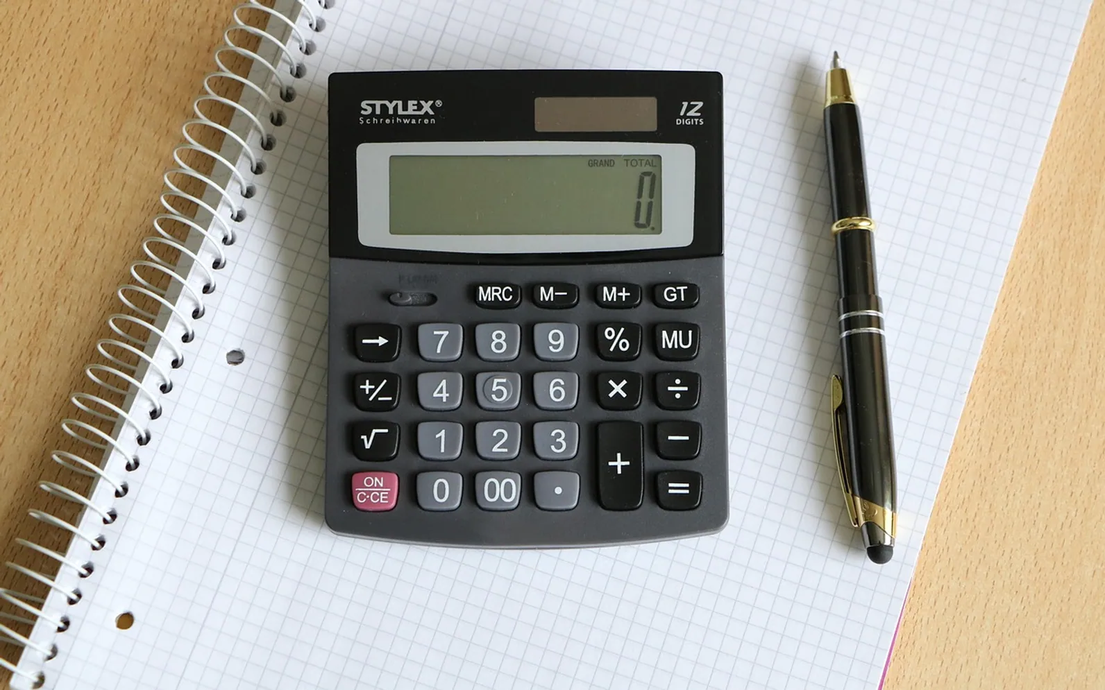 Calculator, ballpoint pen and block